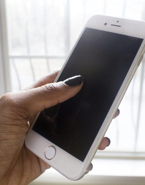 black-woman-holding-smartphone-createherstock